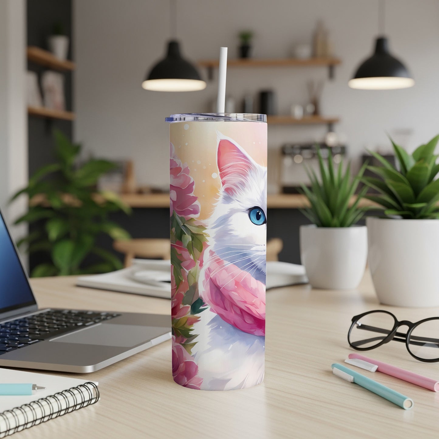 White cat with blue eyes on a floral tumbler with a pink scarf.