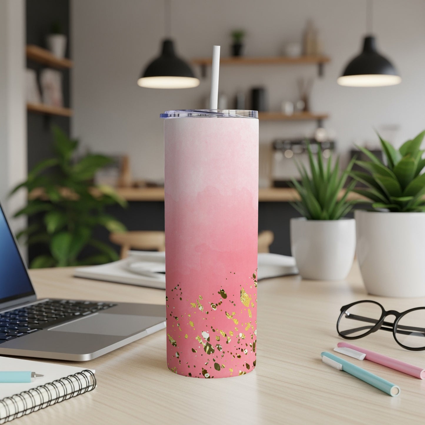 Pink gradient tumbler with gold glitter accents and a white straw.