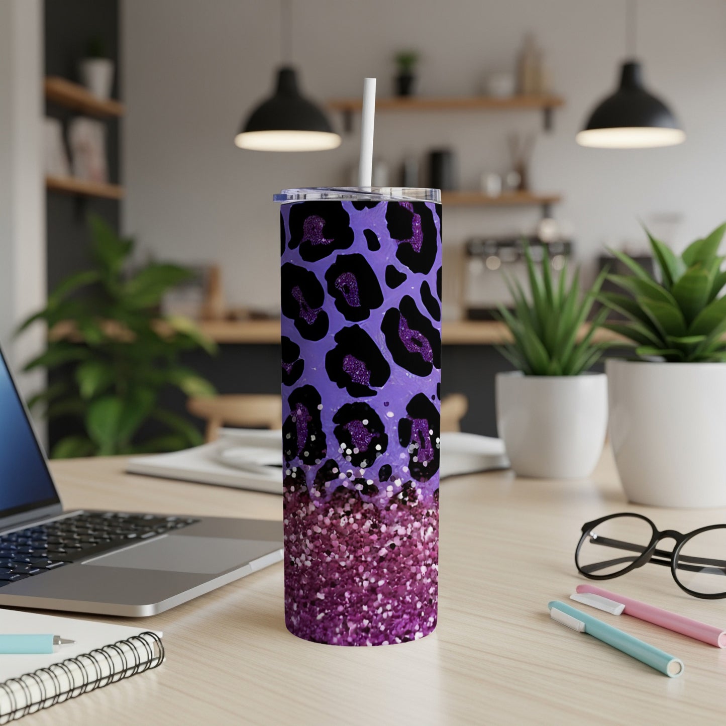Purple glitter leopard print tumbler with straw on desk.