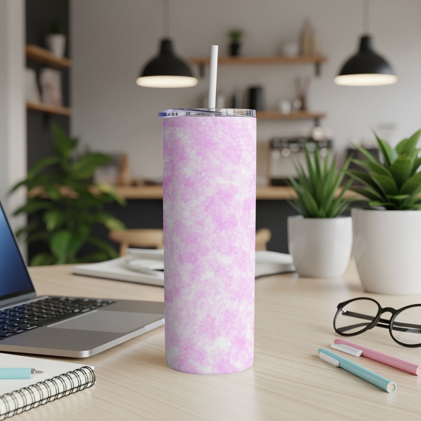 Pink and white marble pattern tall tumbler with a white straw.