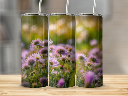 Three tumblers featuring a close-up of pink and purple wildflowers in soft sunlight.
