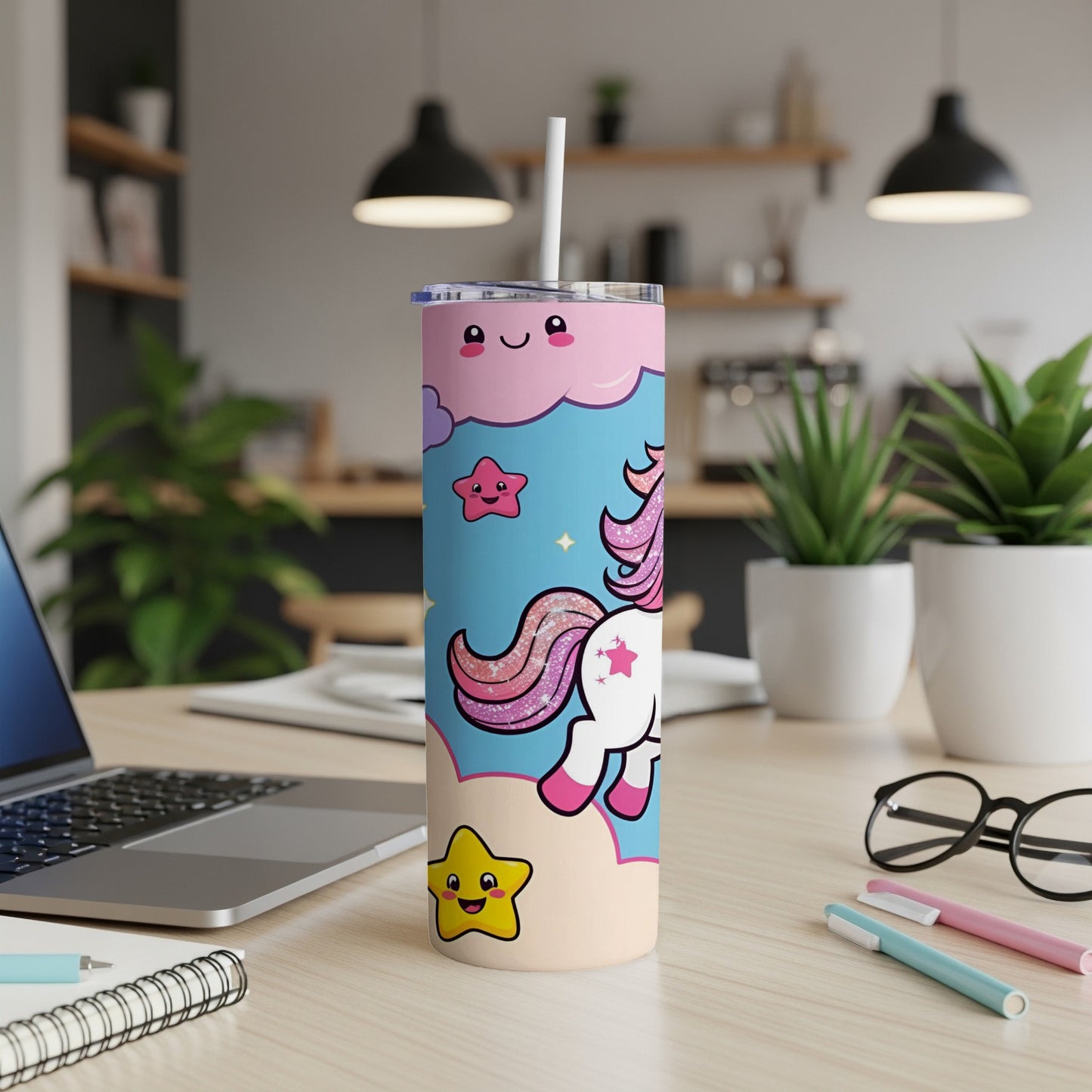 Pink unicorn with stars and clouds on a light blue and peach tumbler with straw.