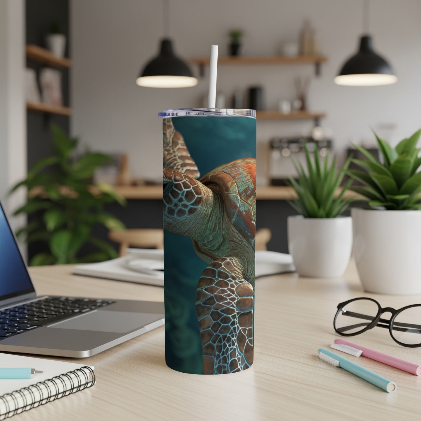 Sea turtle swimming in blue water on a skinny tumbler with a straw.