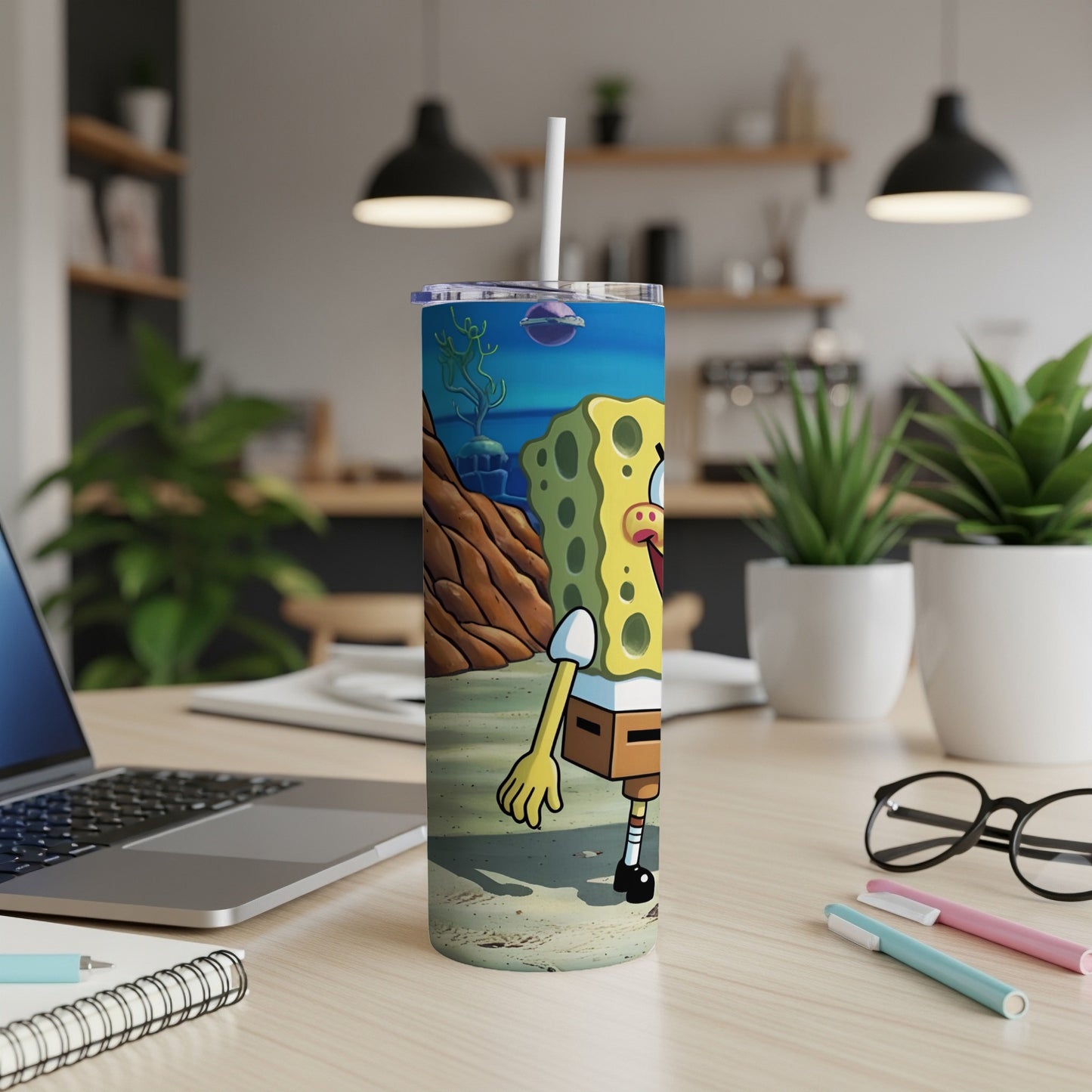 SpongeBob SquarePants on a beach with a straw in a tumbler.