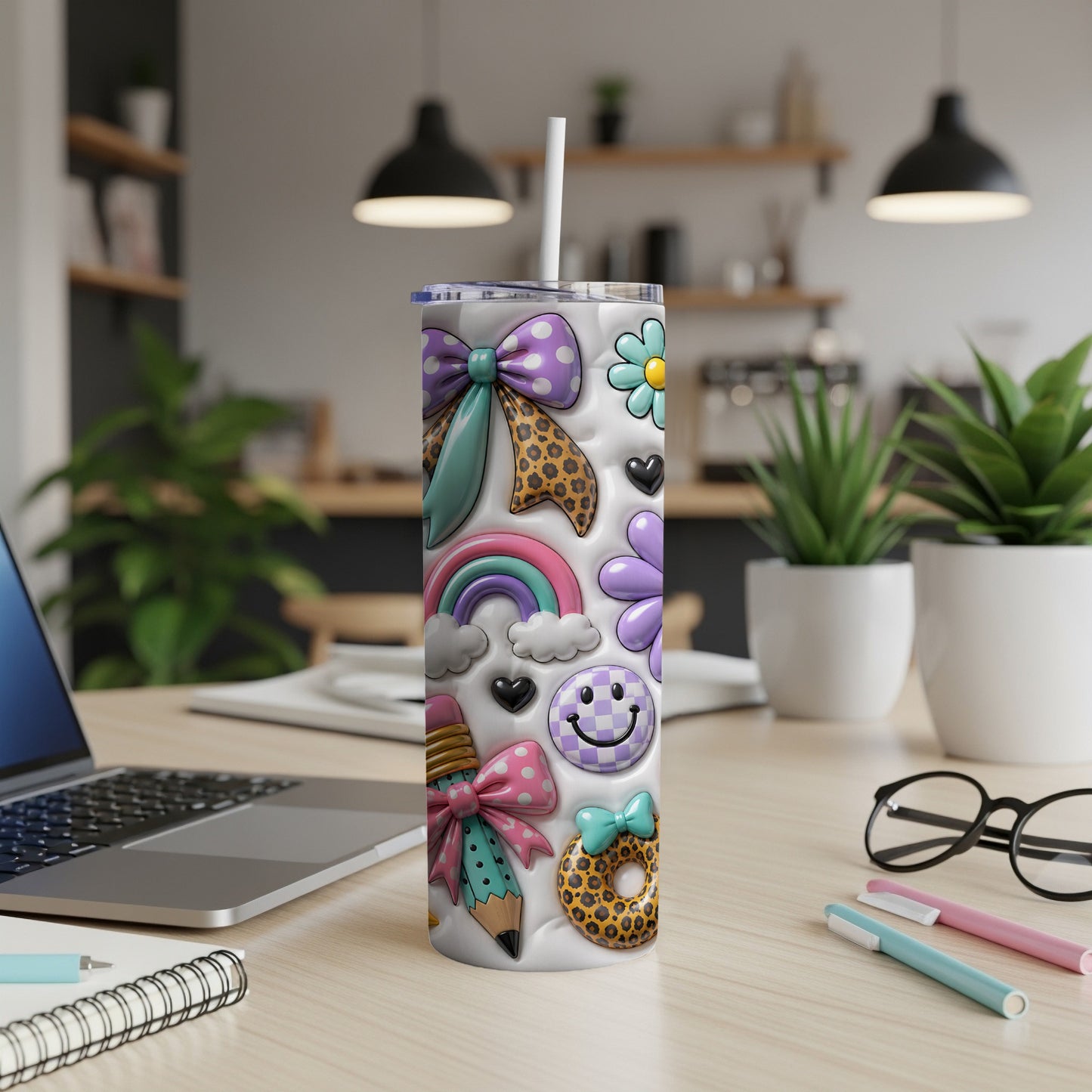 Tumbler with colorful icons: bows, rainbow, pencil, smiley, flowers, donut, and hearts.