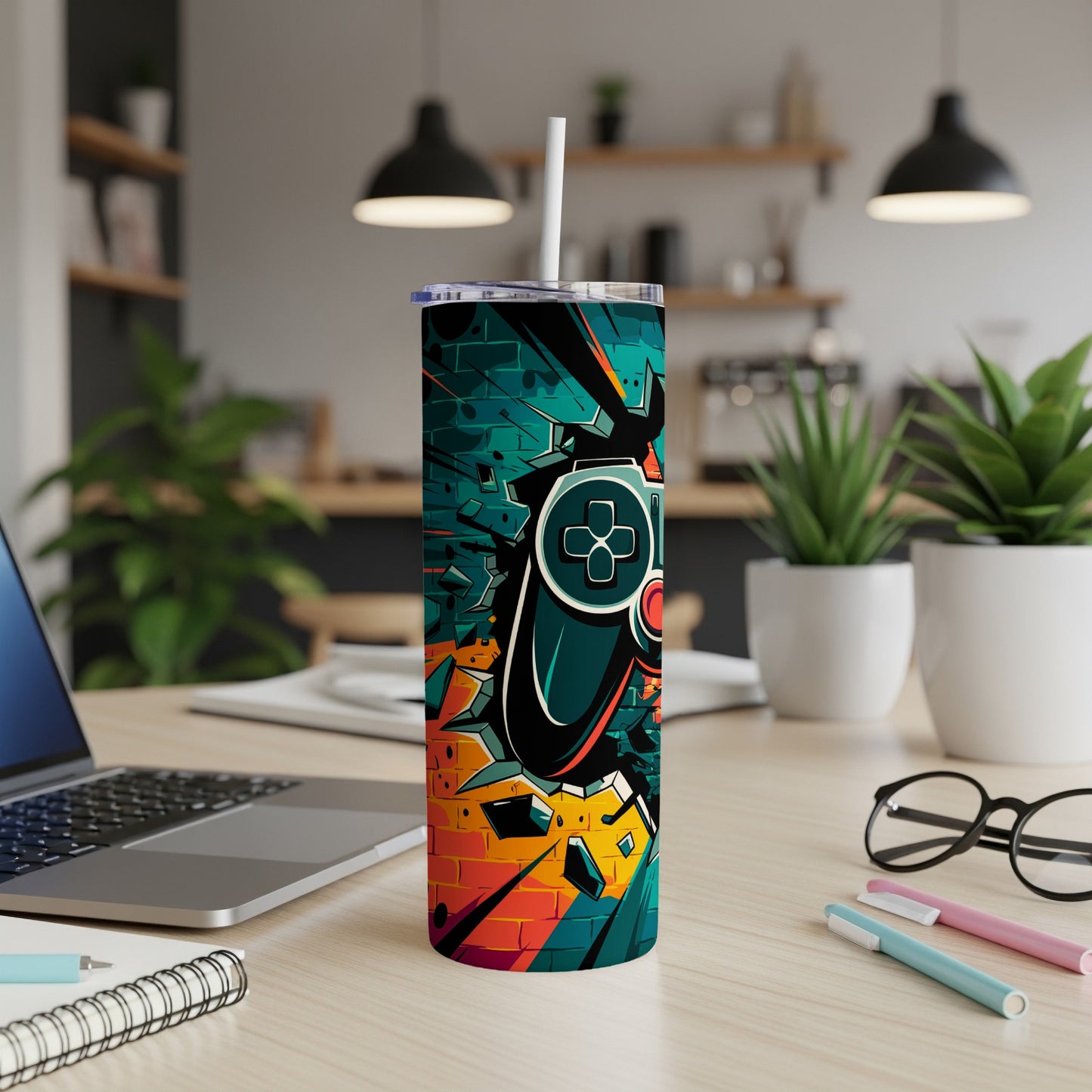 Graffiti-style video game controller on a teal and orange tumbler.