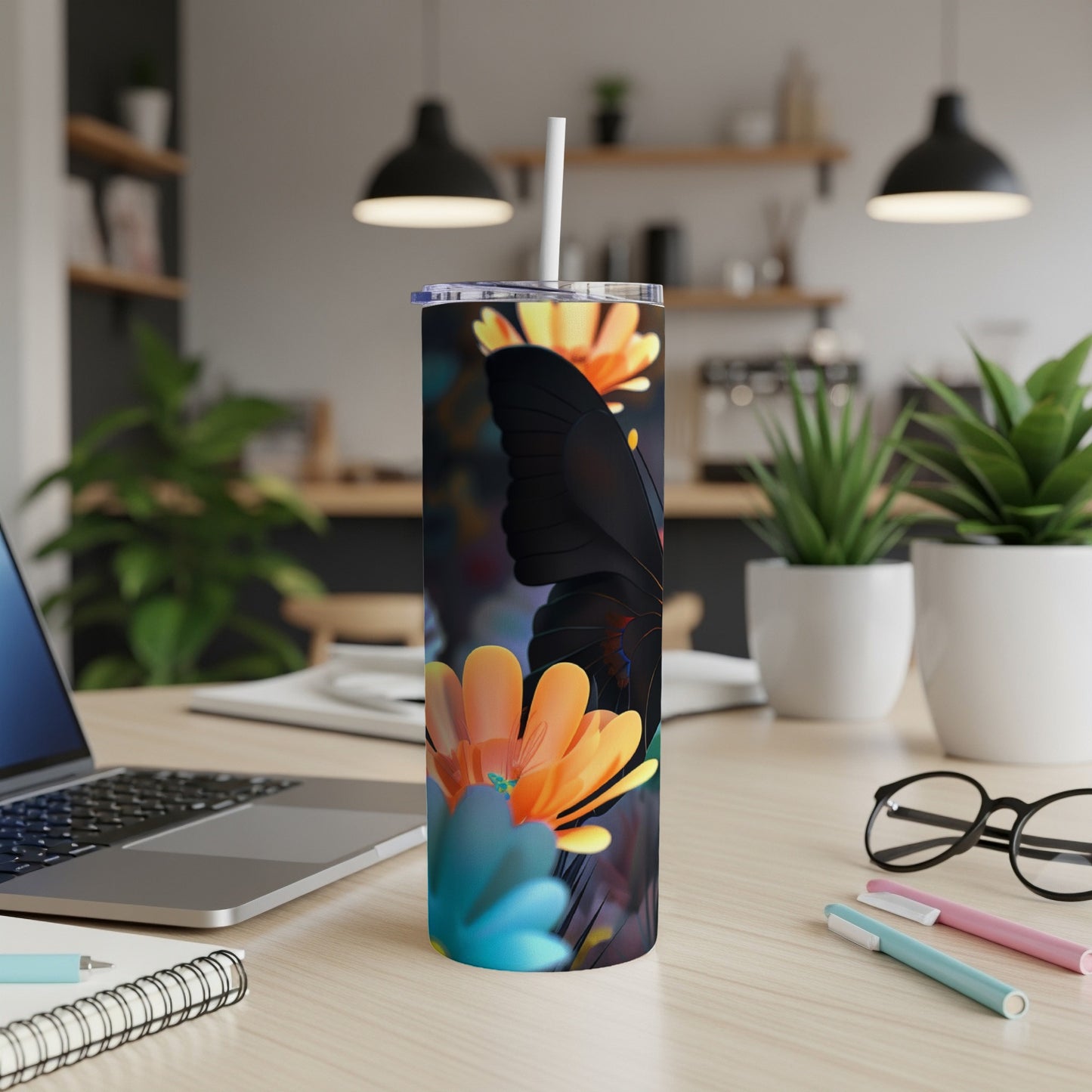 Black butterfly and orange flowers on a white tumbler with a straw.