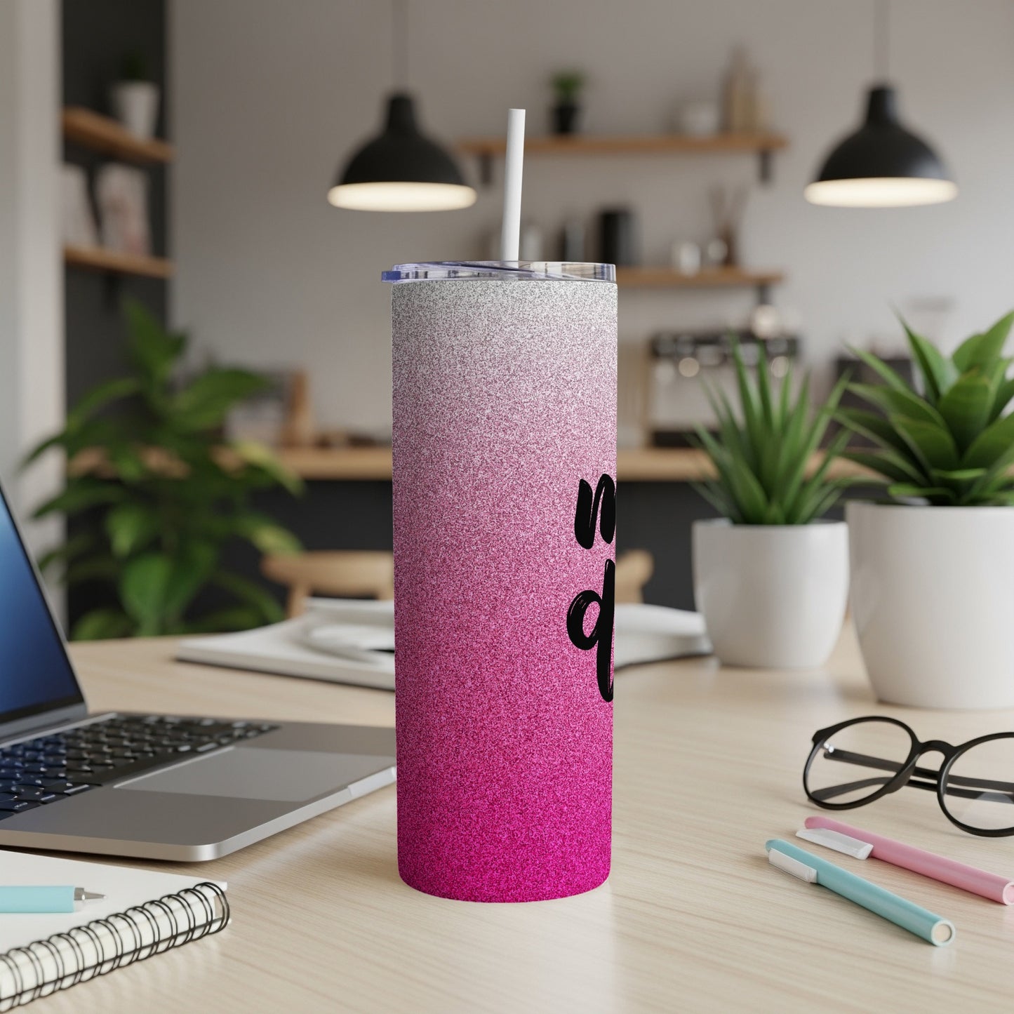 Sparkling pink and silver tumbler with "Mom Life" text on a desk.