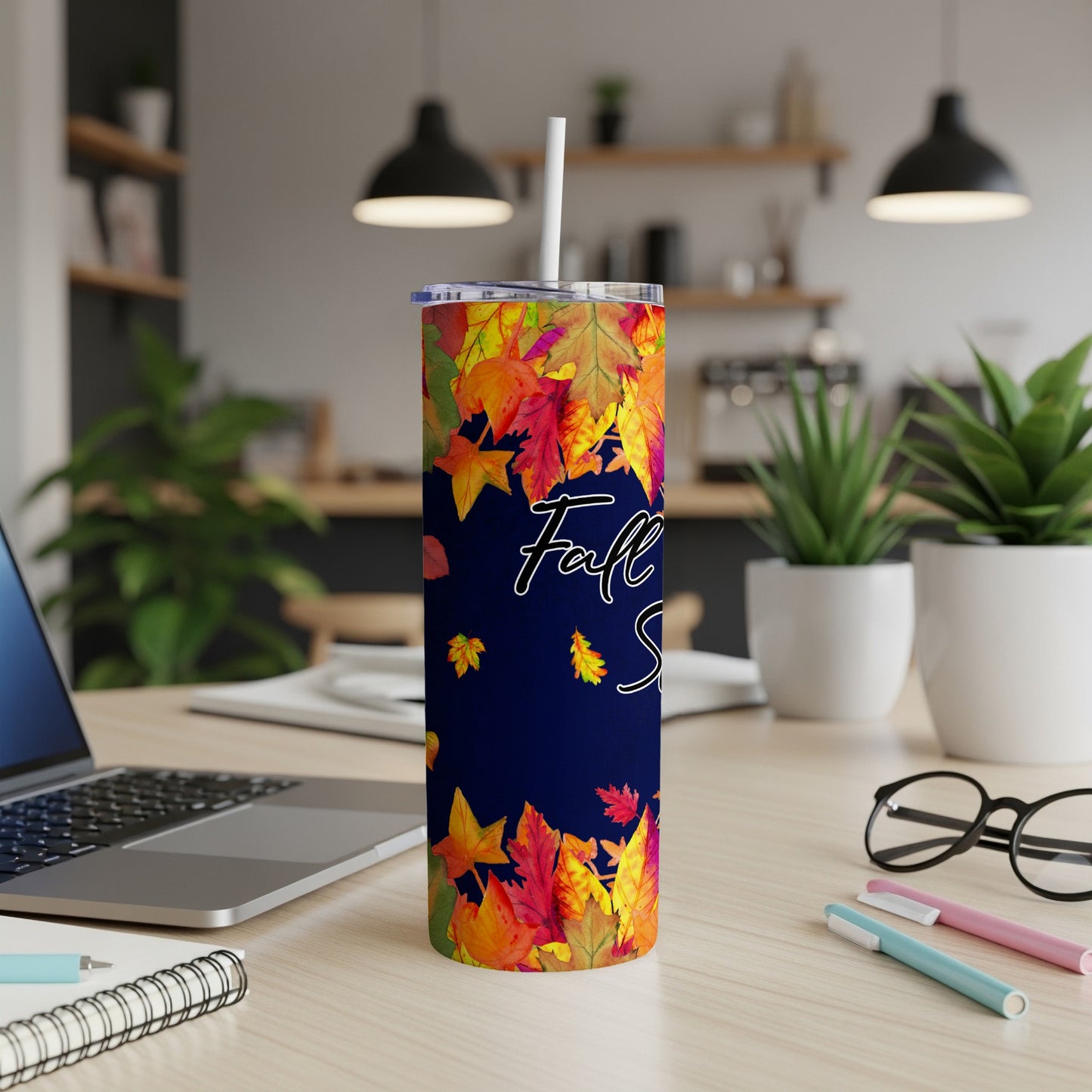 Navy tumbler with falling autumn leaves and "Fall vibes" text.