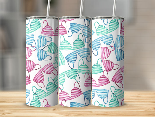 Three skinny tumblers with a watercolor pattern of pink and teal bikinis.