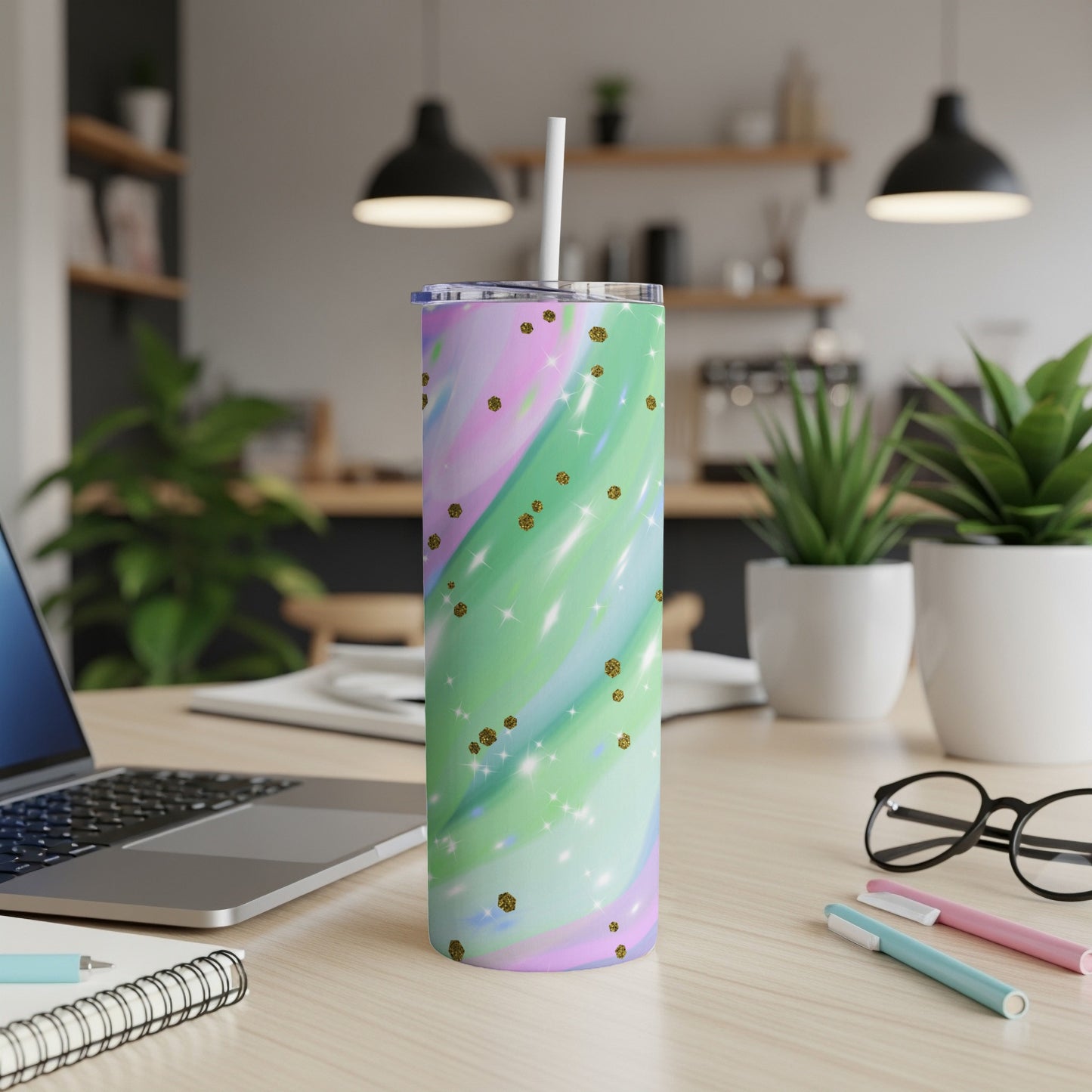 Tumbler with pastel swirl design and gold glitter accents, featuring a straw.