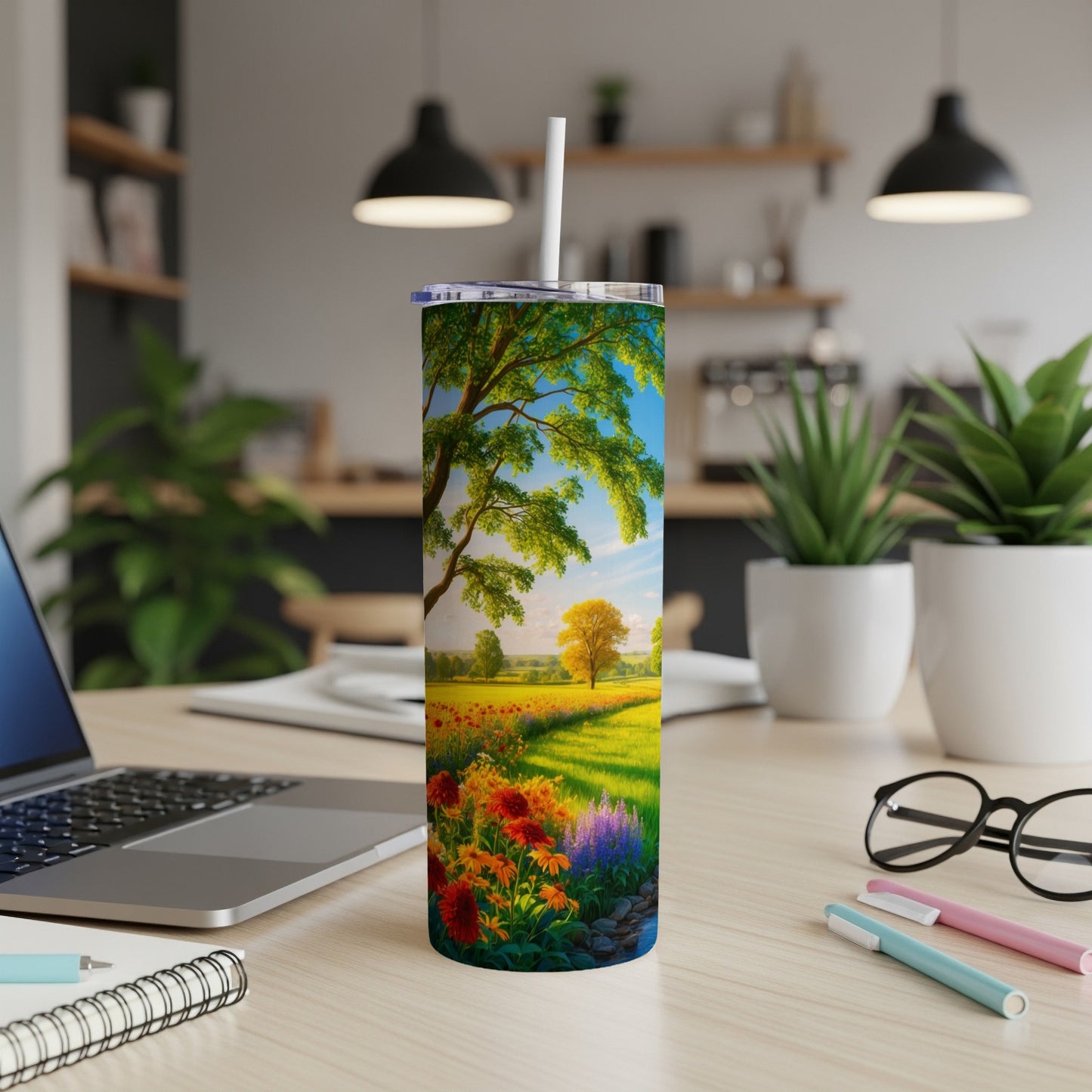 Tall tumbler with a pastoral landscape of flowers, trees, and a sunny field.