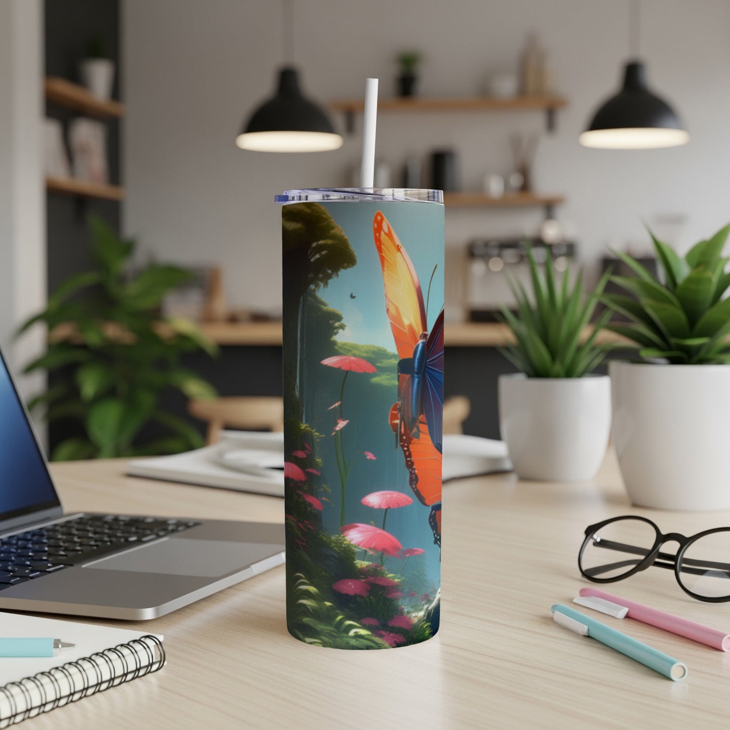 Tumbler with colorful butterfly and floral design on a desk.