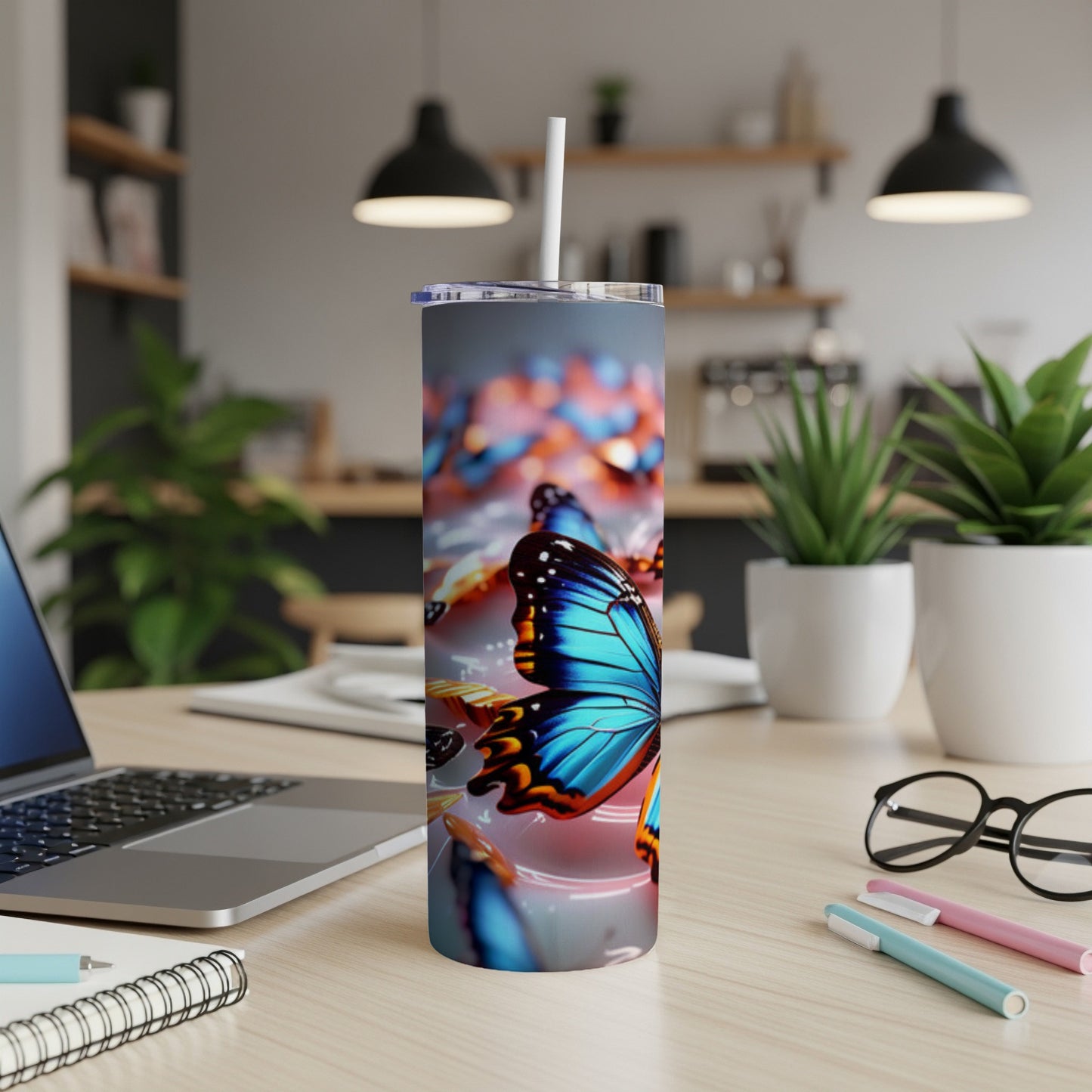 Tumbler with blue and orange butterflies and metallic accents.