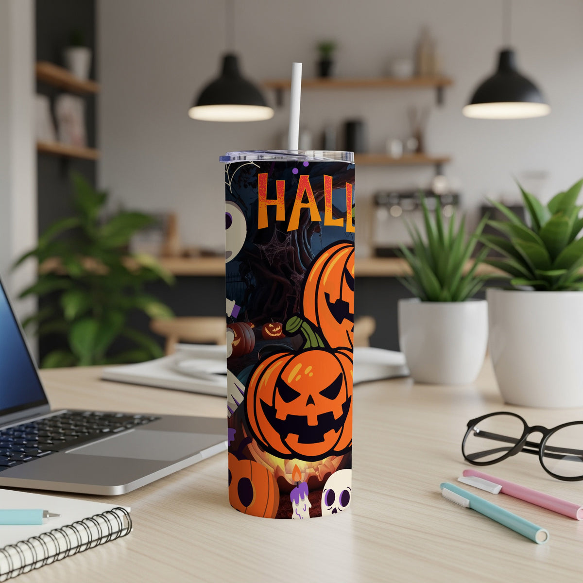 Halloween tumbler with pumpkins, skulls, and the word "HALLOWEEN" against a dark background.