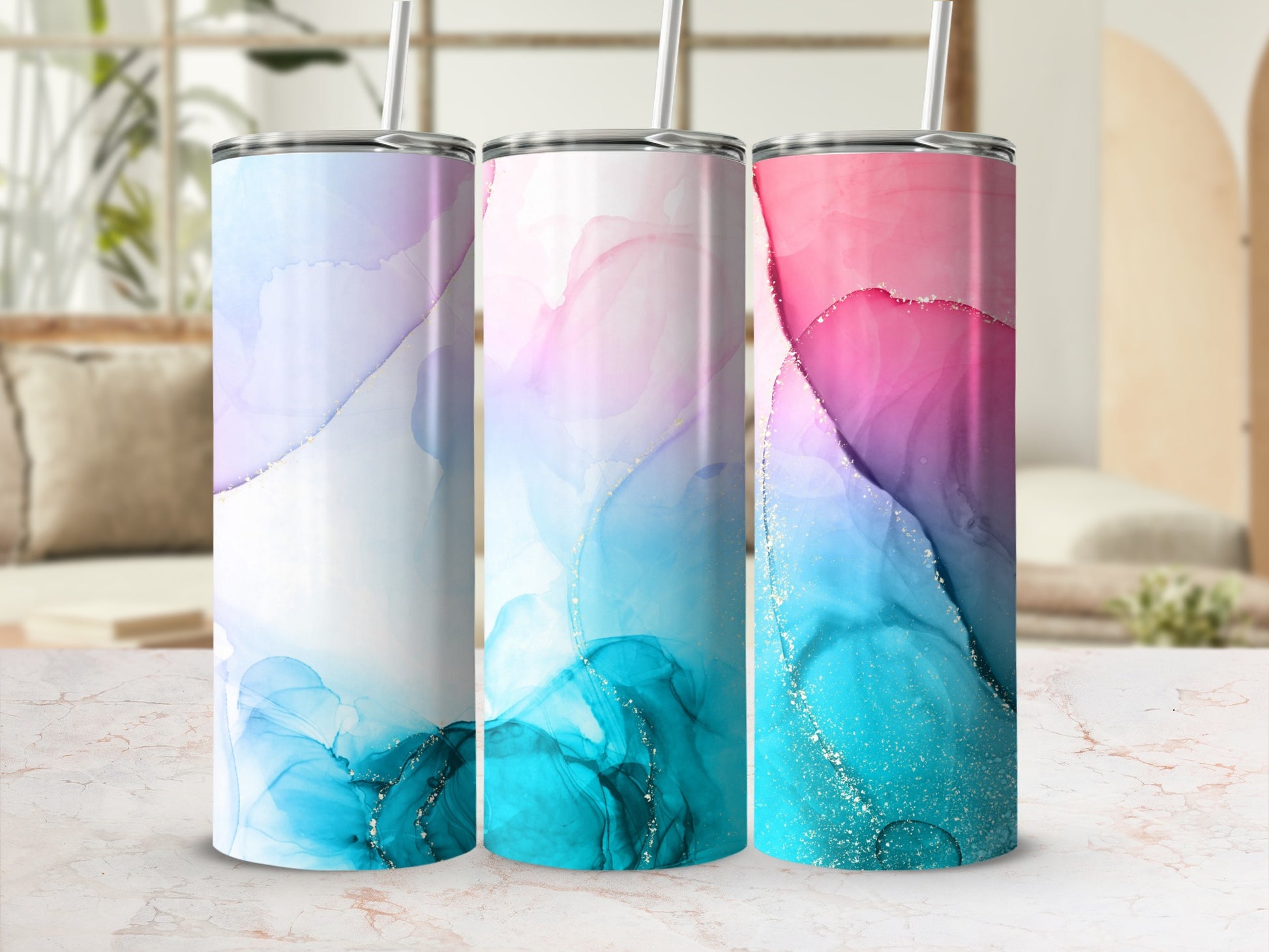 Three tumblers with marbled watercolor designs in pink, blue, and gold.