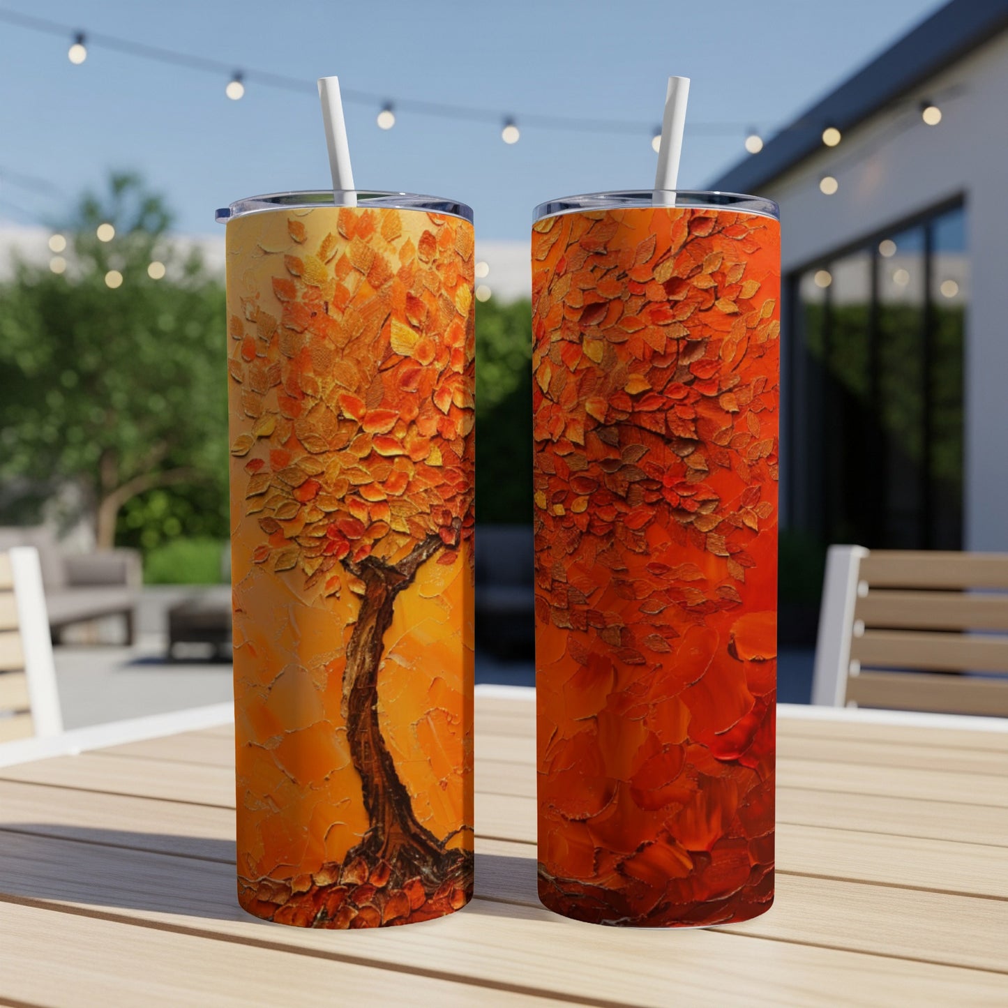 Two tall tumblers with vibrant textured fall tree art, on a table.