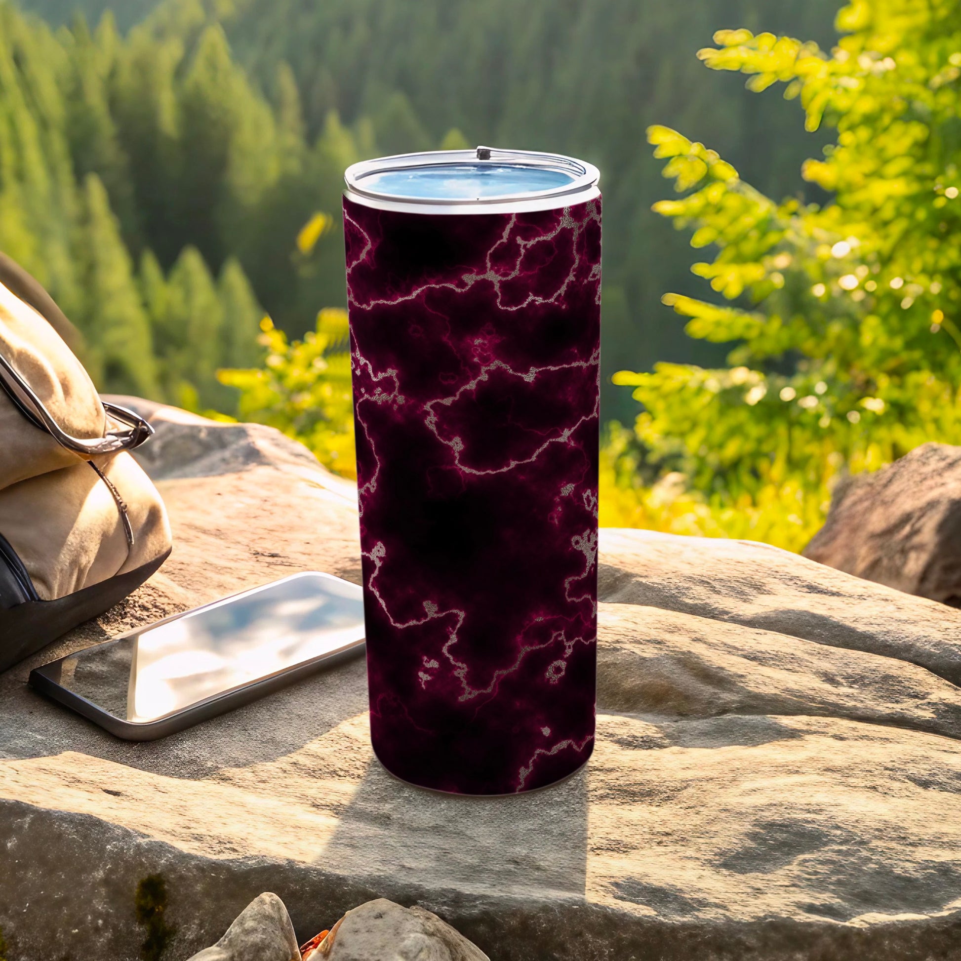Tumbler with marble-like dark purple and black pattern on a rock.