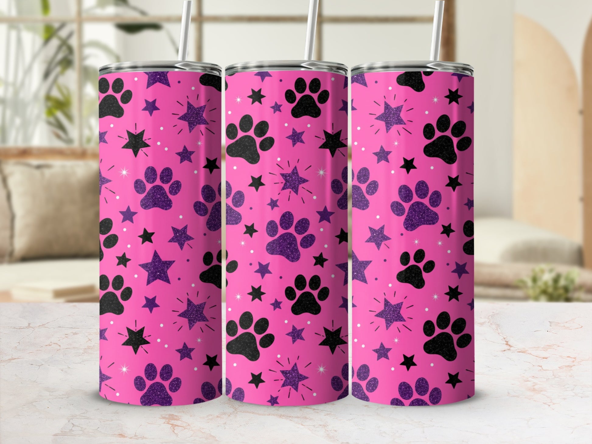 Pink tumbler with purple paw prints and black stars.