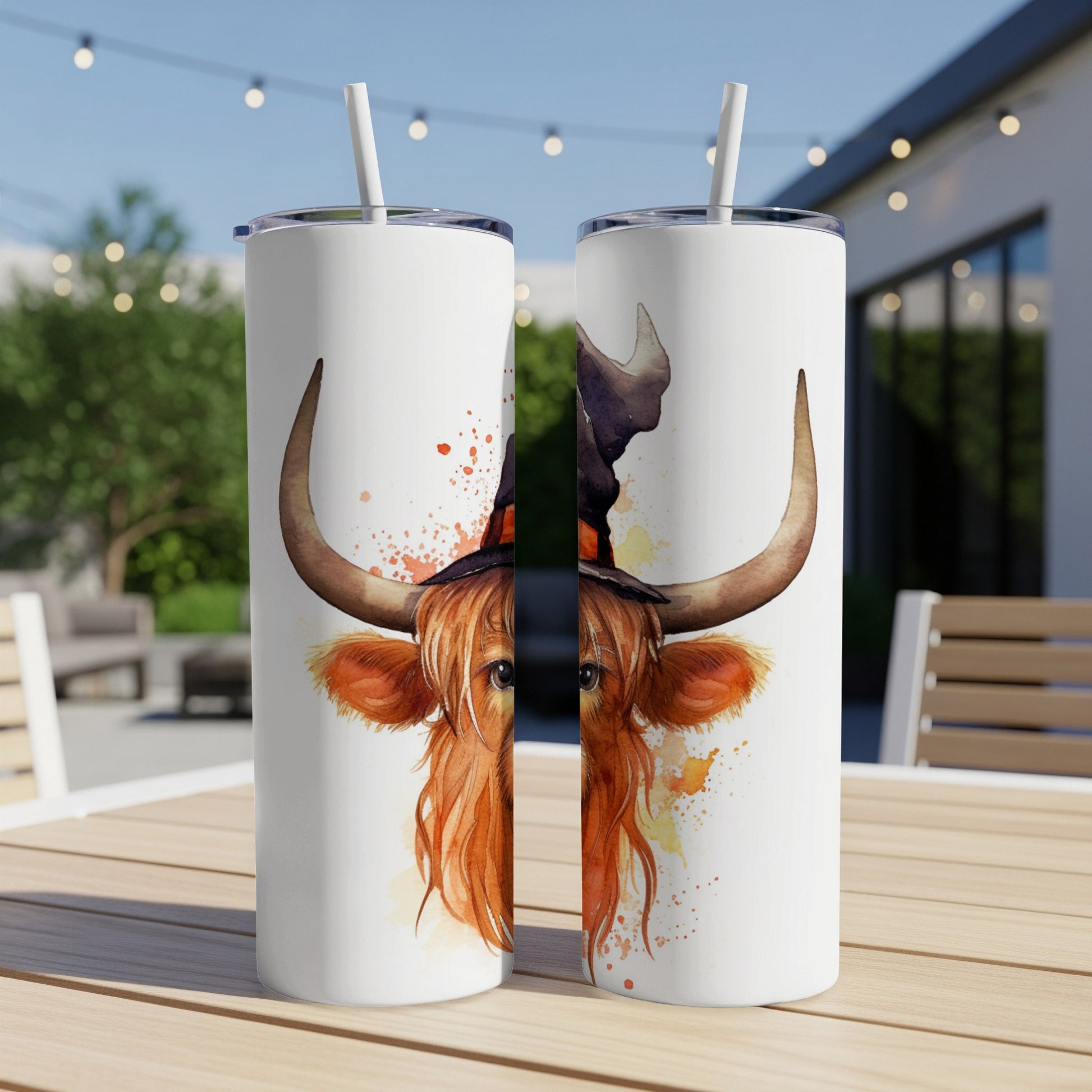 Highland cow wearing witch hat, watercolor style, on two tumblers.