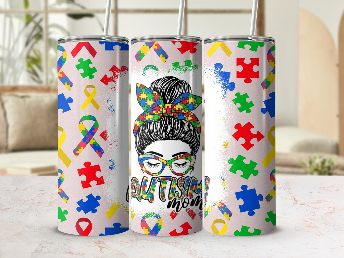 Tumbler with autism puzzle pieces and "Autism Mom" design.