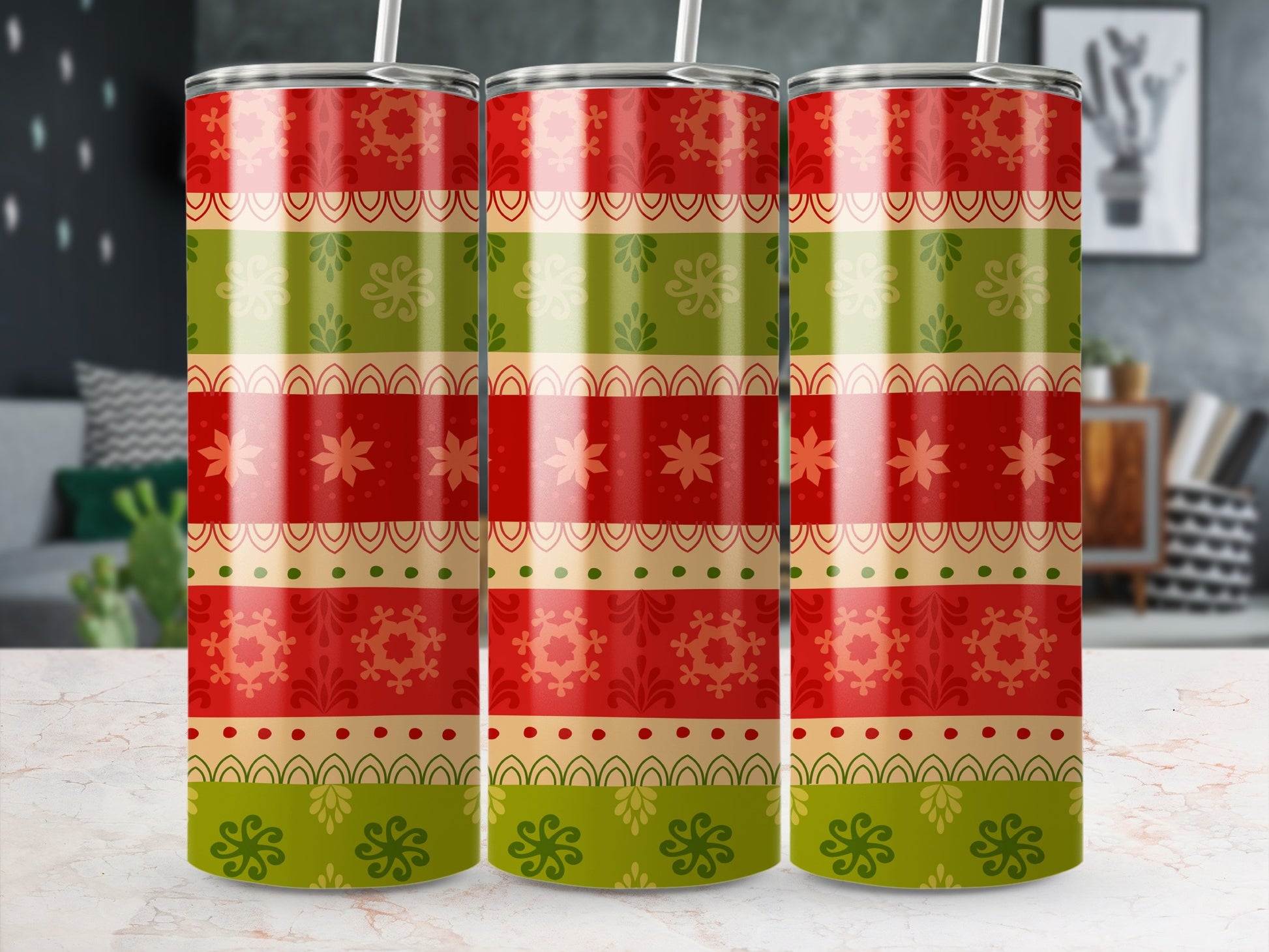 Three tumblers with red, green, and gold festive patterned wraps.