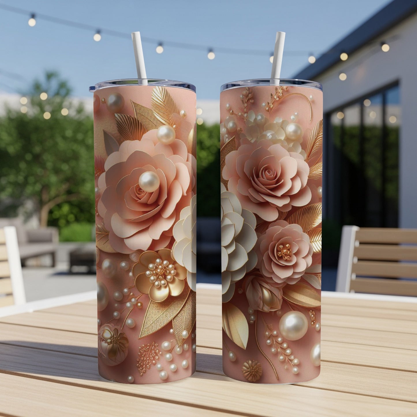 Pink floral tumbler with pearl and gold accents on a table.