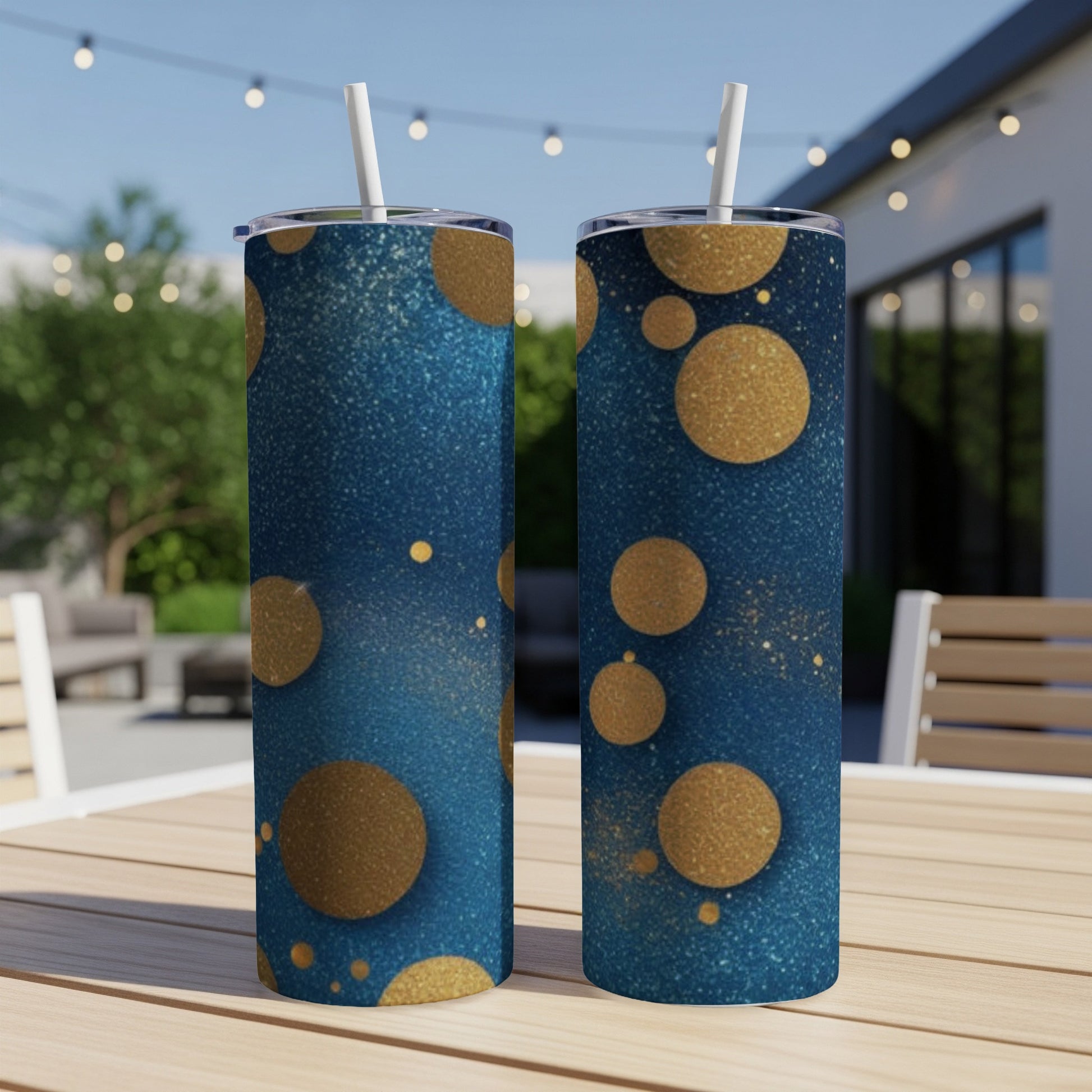 Two blue tumblers with gold glitter circles and speckles.