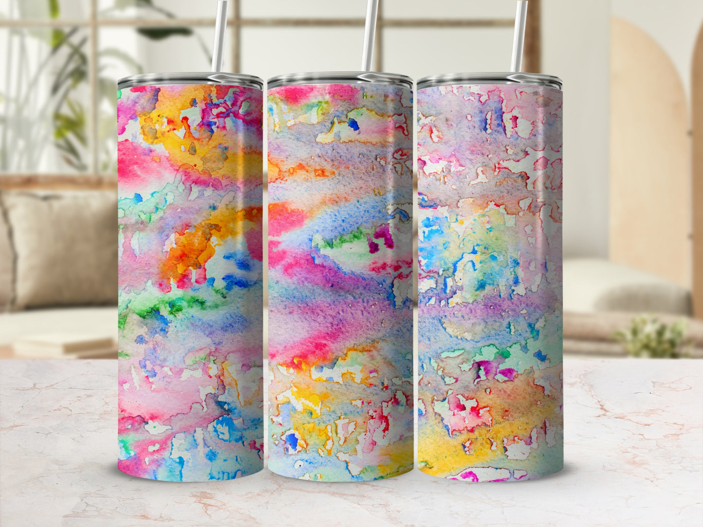 Abstract watercolor art on three tumblers with straws.