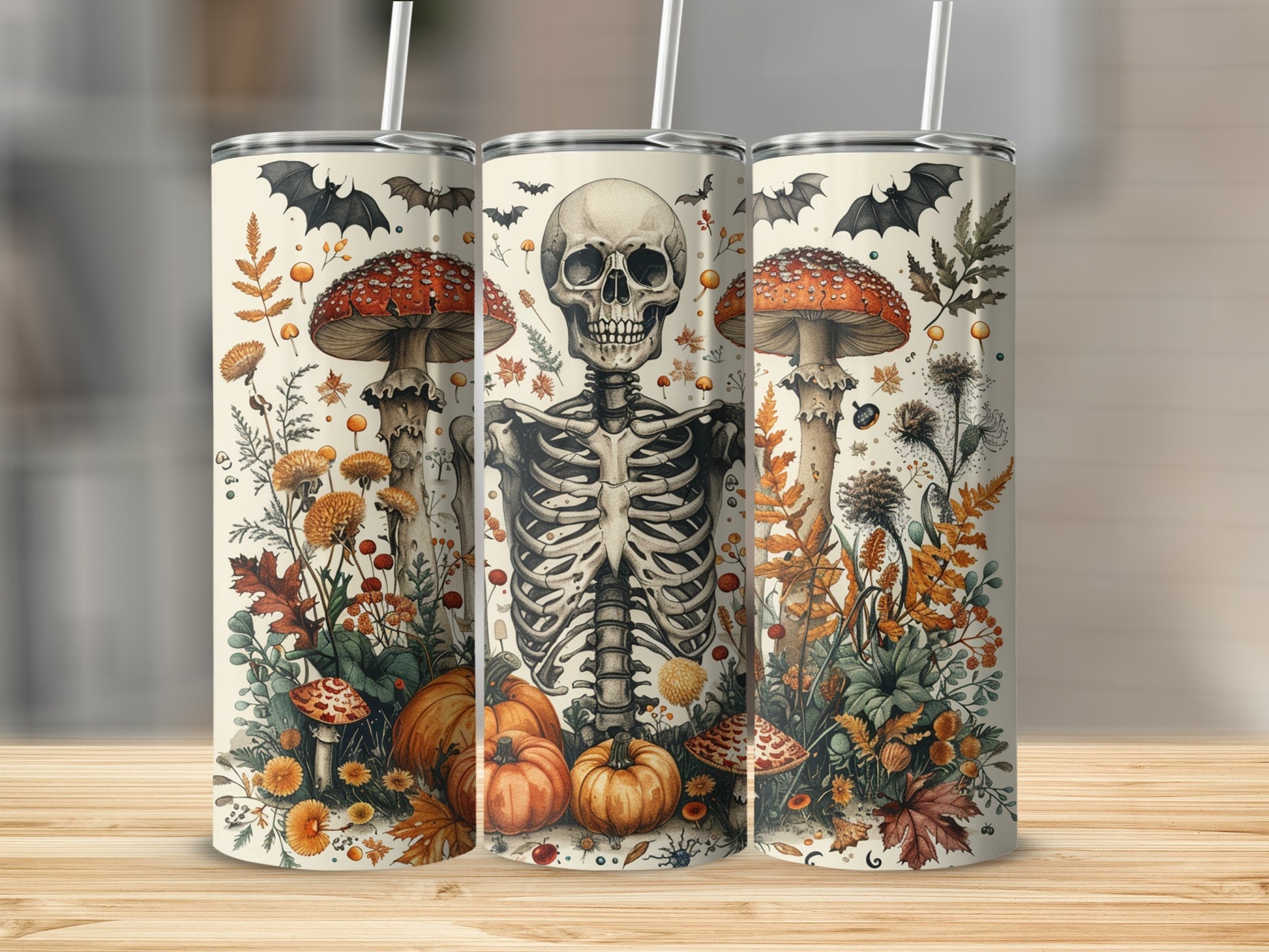Three tumblers with a skeleton, mushrooms, bats, pumpkins, and autumn leaves design.