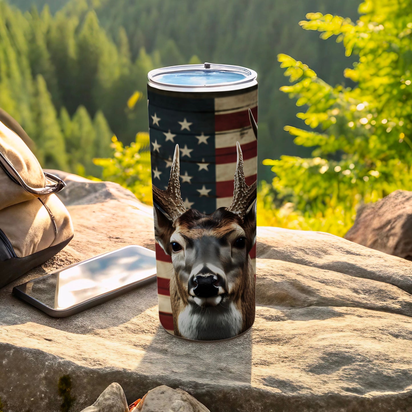 Deer head and American flag design on a stainless steel tumbler.
