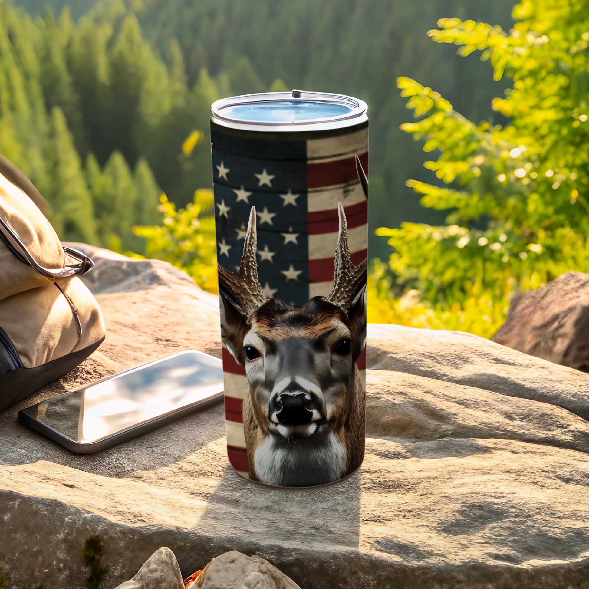 Deer head and American flag design on a stainless steel tumbler.
