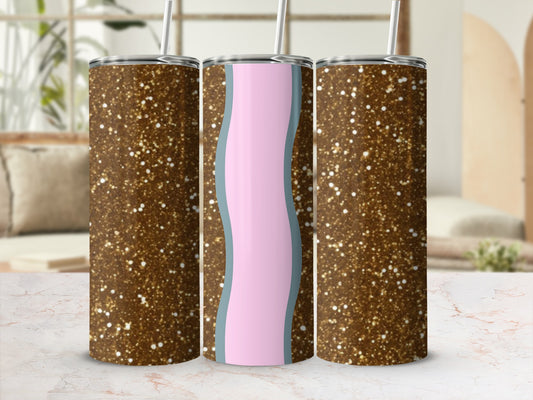 Three glittery tumblers with pastel wave designs stand on a marble countertop.