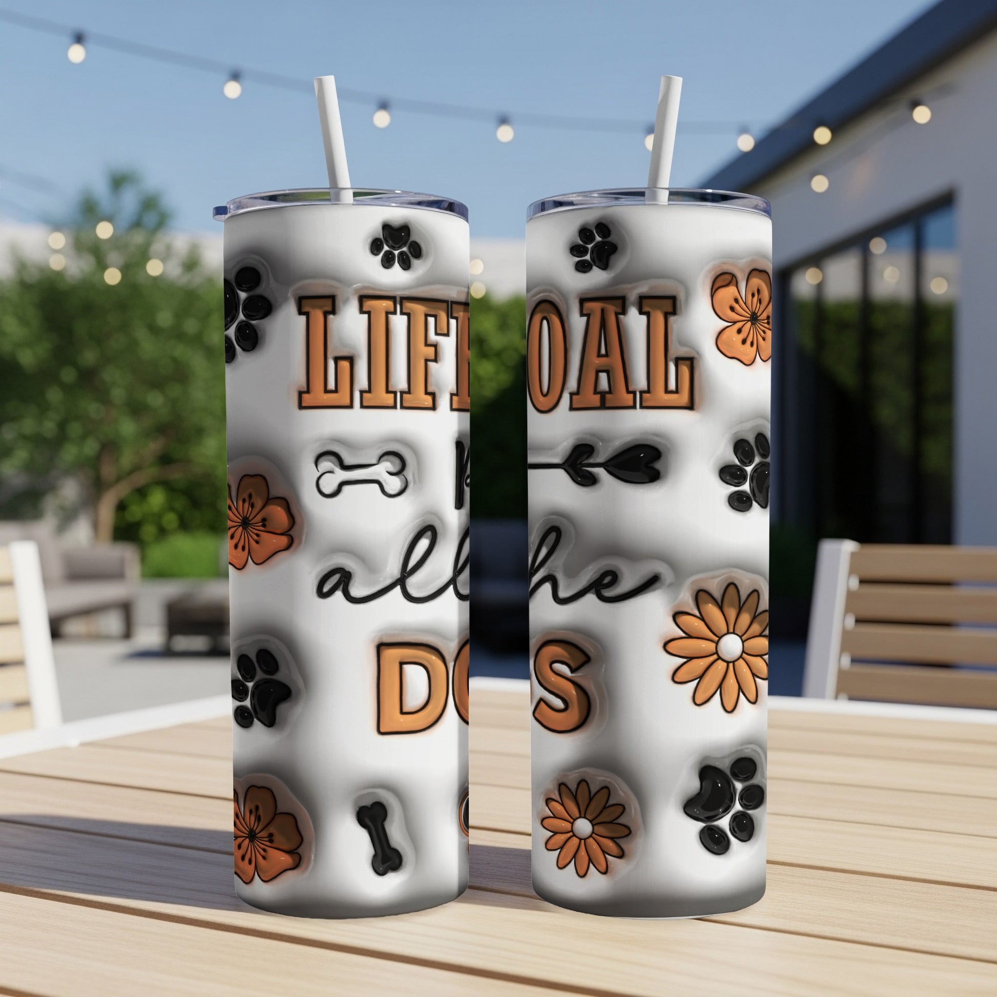 Tumbler with "Life goal: all the dogs" and dog paw prints.