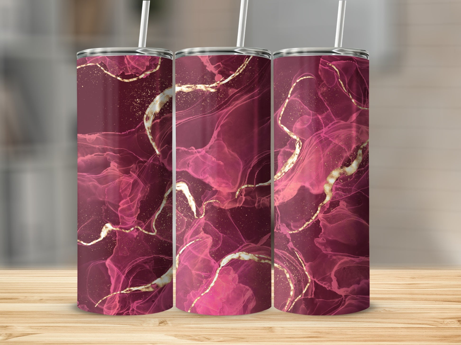 Three burgundy tumblers with abstract pink and gold marbling designs.