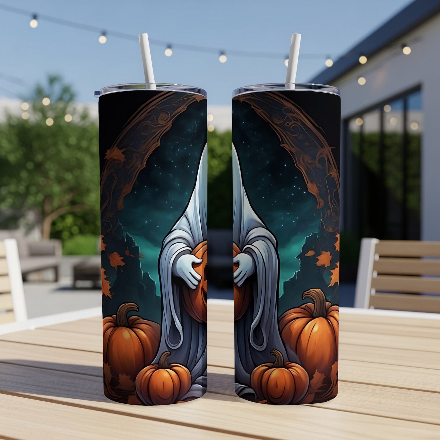 Two tumblers with a Halloween ghost and pumpkins design, set on a wooden table outdoors.