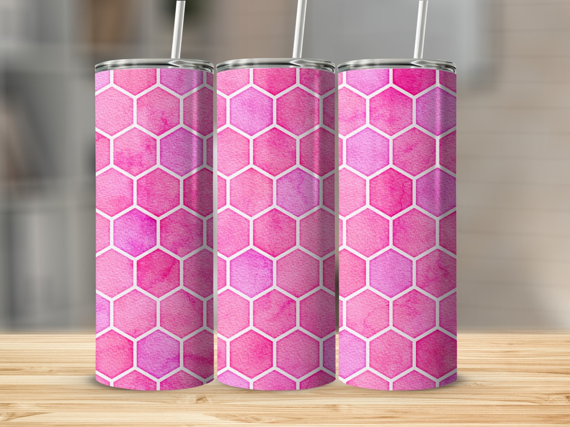 Three tumblers with pink and purple watercolor honeycomb pattern and white straws.