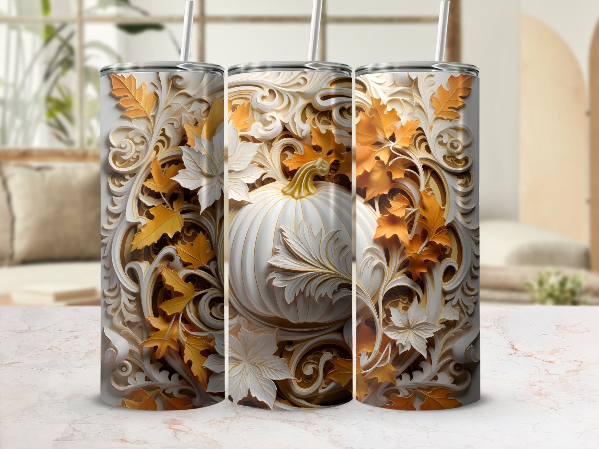 White pumpkin and autumn leaves adorn three decorative tumblers.