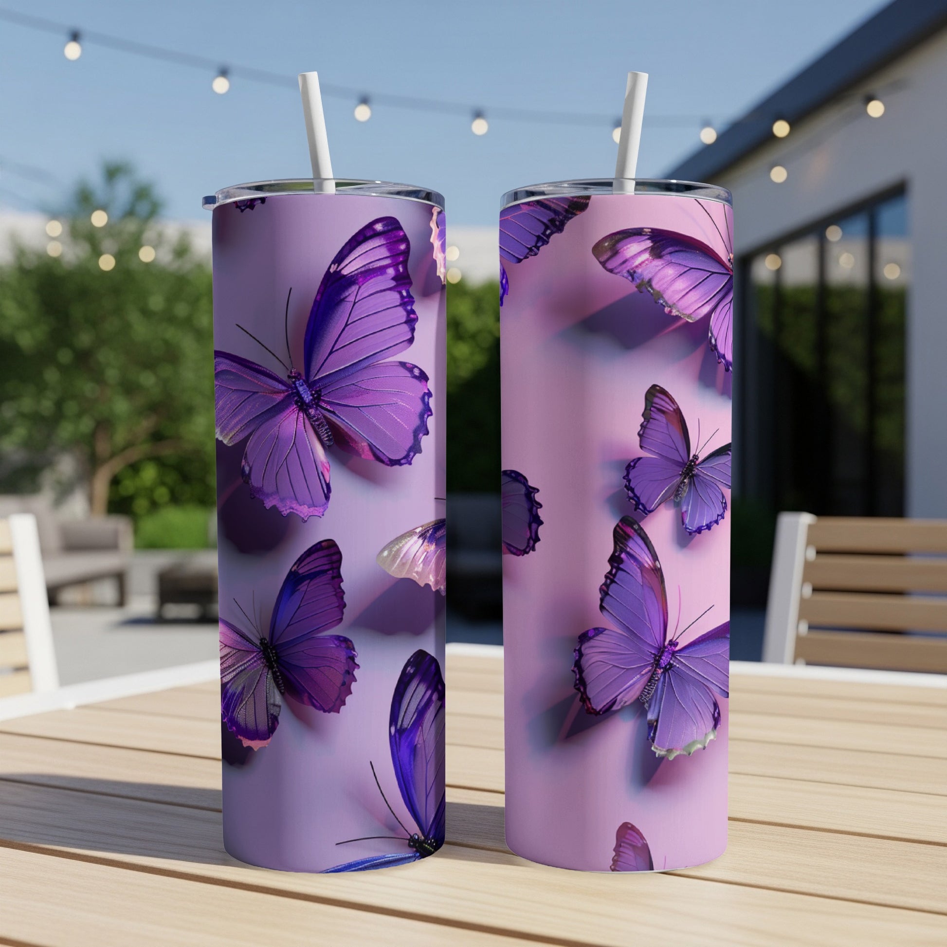 Two purple butterfly tumblers with straws on a wooden table.