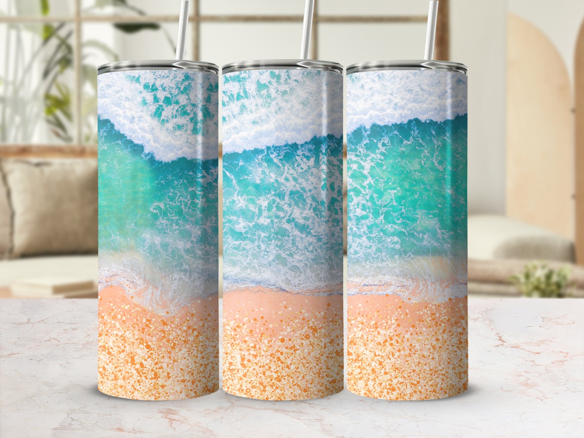 Three tumblers with ocean wave and sandy beach design.