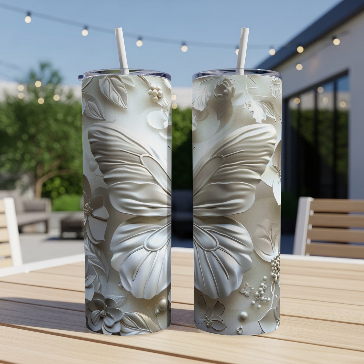 Two silver tumblers with intricate butterfly and floral embossed designs.