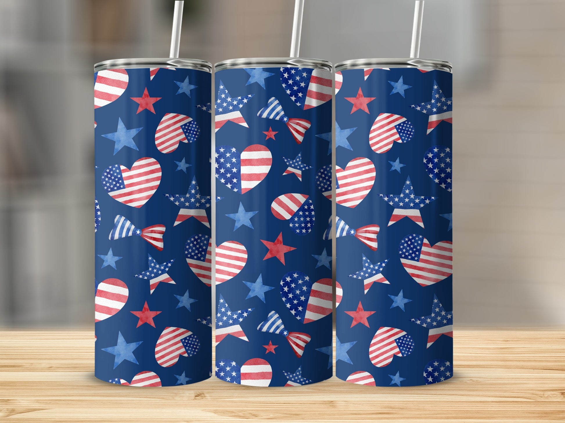Three tumblers with patriotic American flag heart and star patterns on dark blue background.