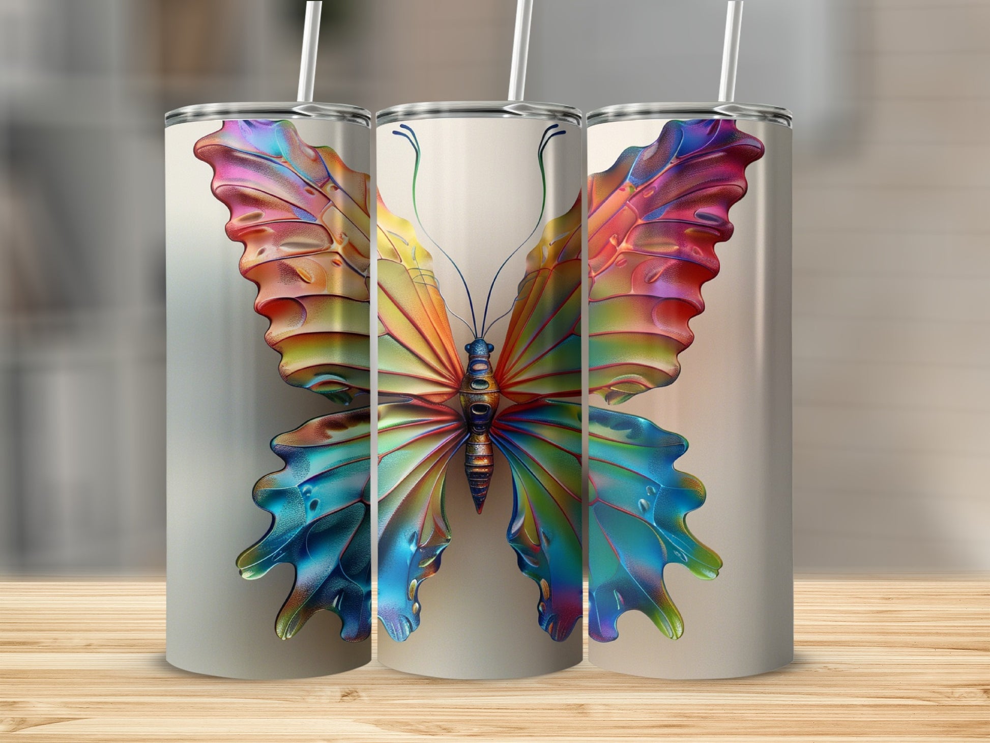 Three tumblers with vibrant, colorful butterfly designs.