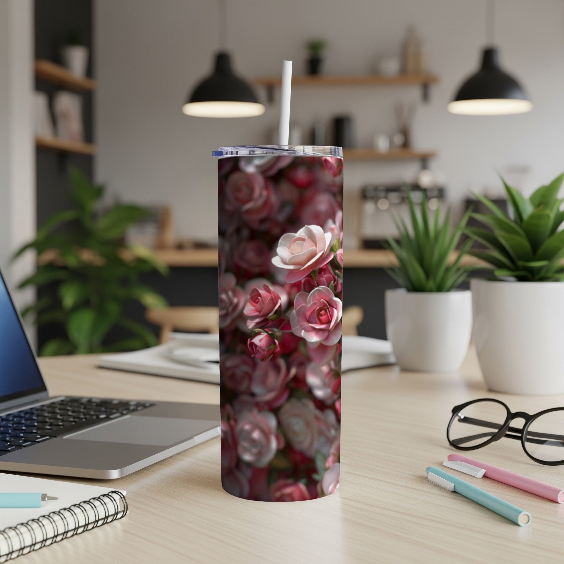 Pink and white roses pattern on a stainless steel tumbler.
