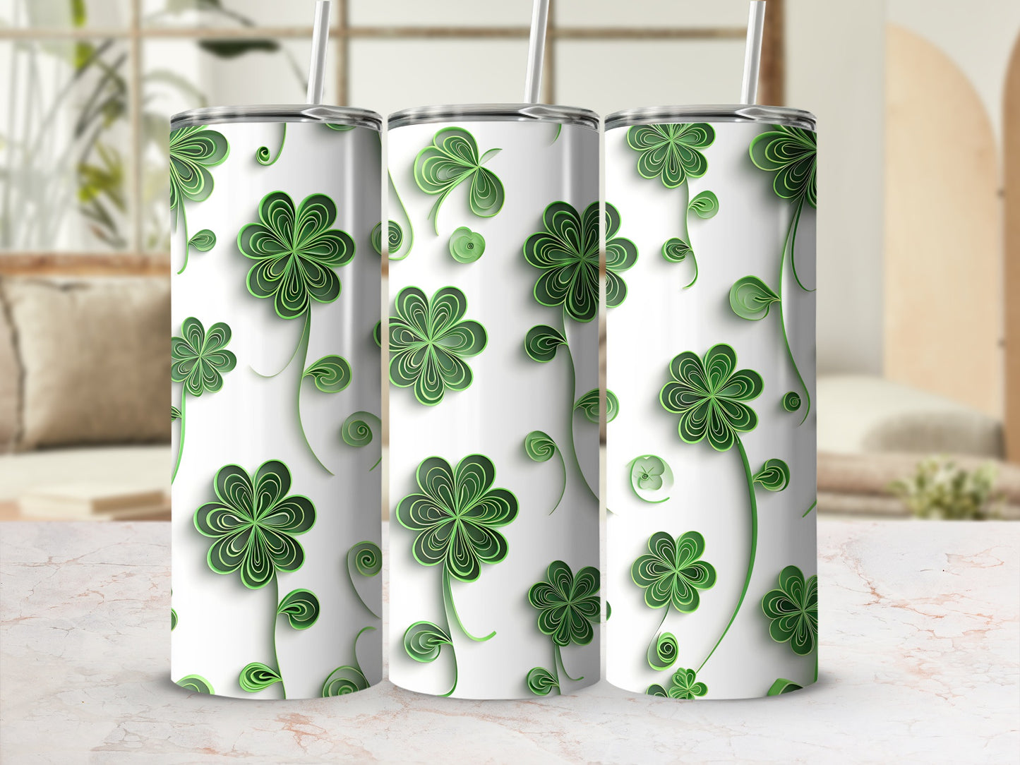 Three white tumblers with green clover pattern and straws.