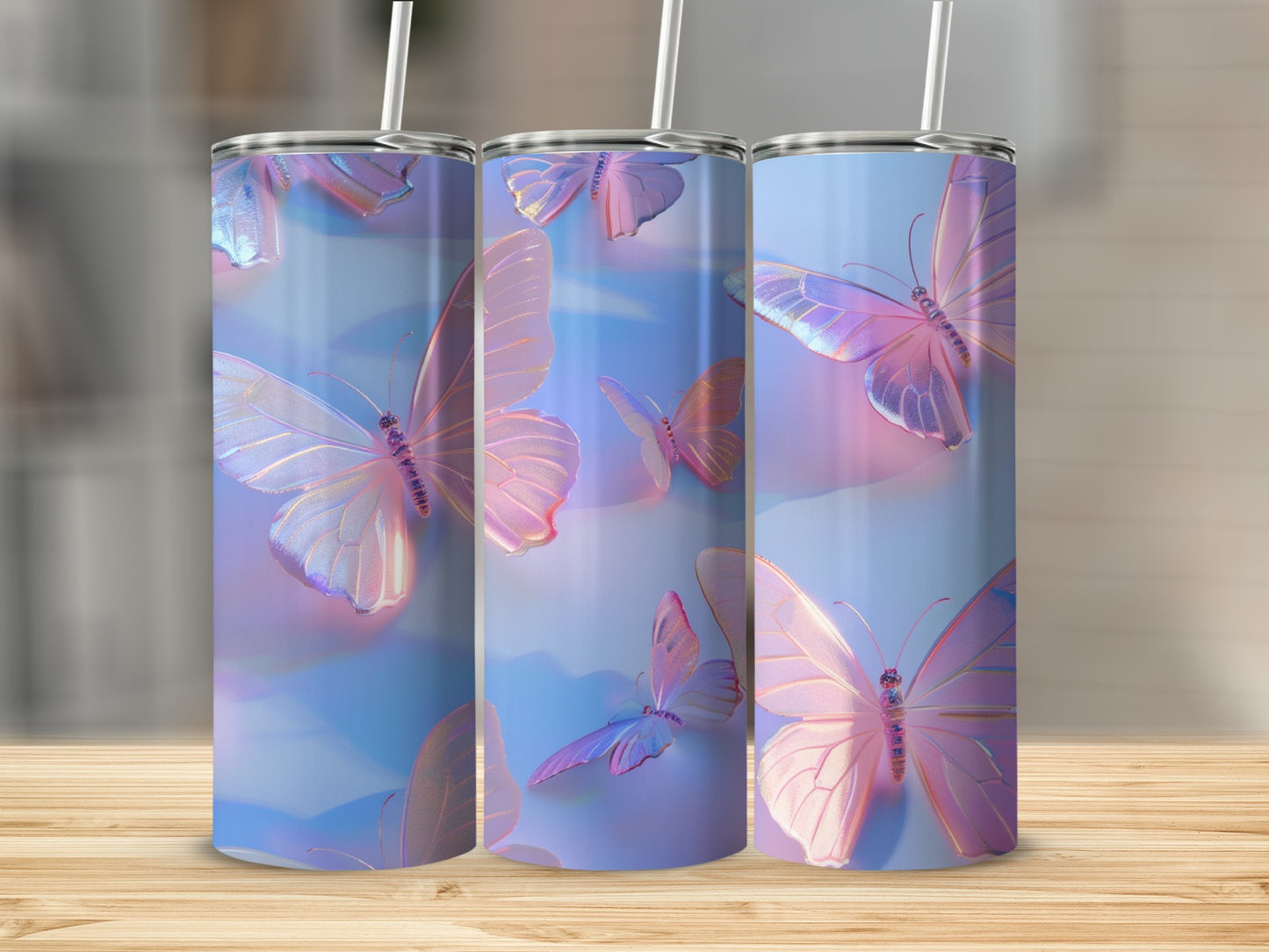 Three tumblers with iridescent butterflies and pastel blue and pink backgrounds.