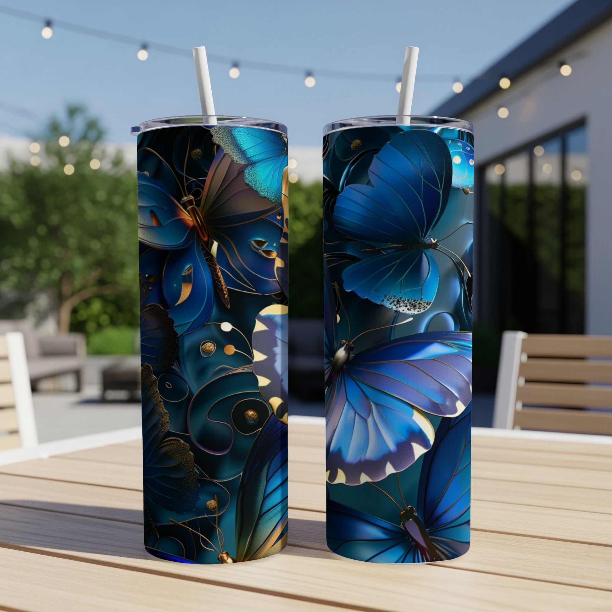 Two blue butterfly tumblers with gold accents on a table.