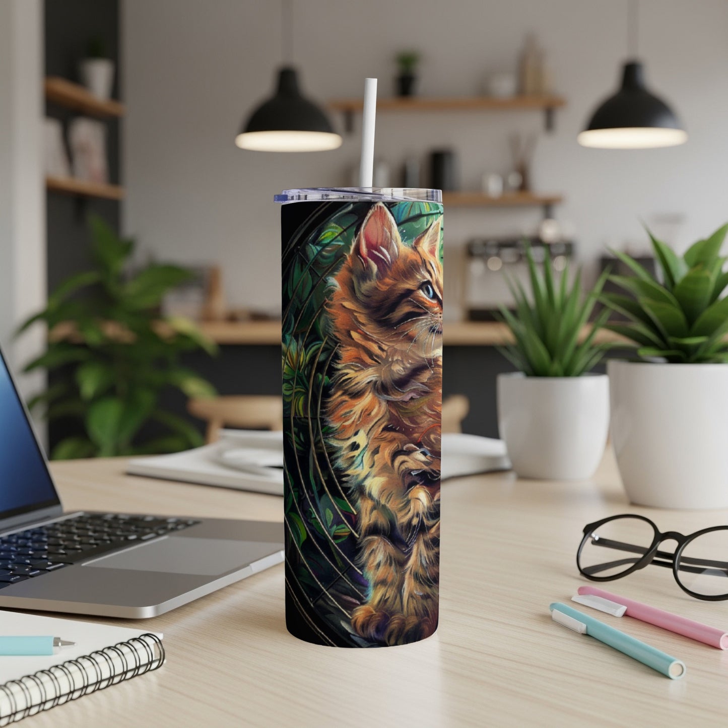Cat illustration on a tall, slender tumbler with a straw.