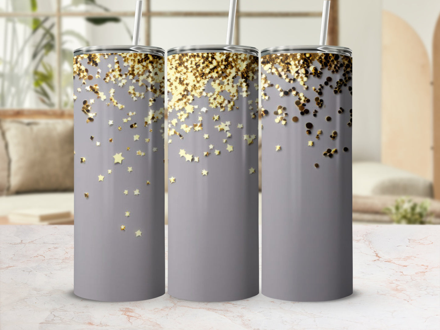 Three tumblers with gold glitter stars on a gray background.