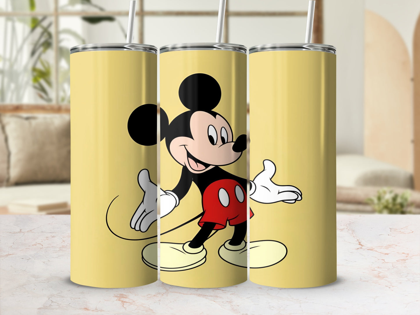 Three yellow tumblers featuring Mickey Mouse.